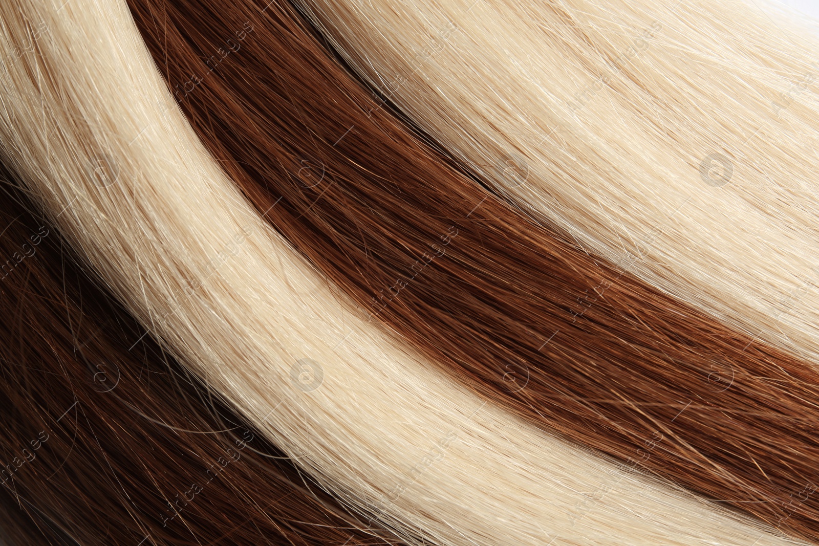 Photo of Strands of different color hair as background, closeup