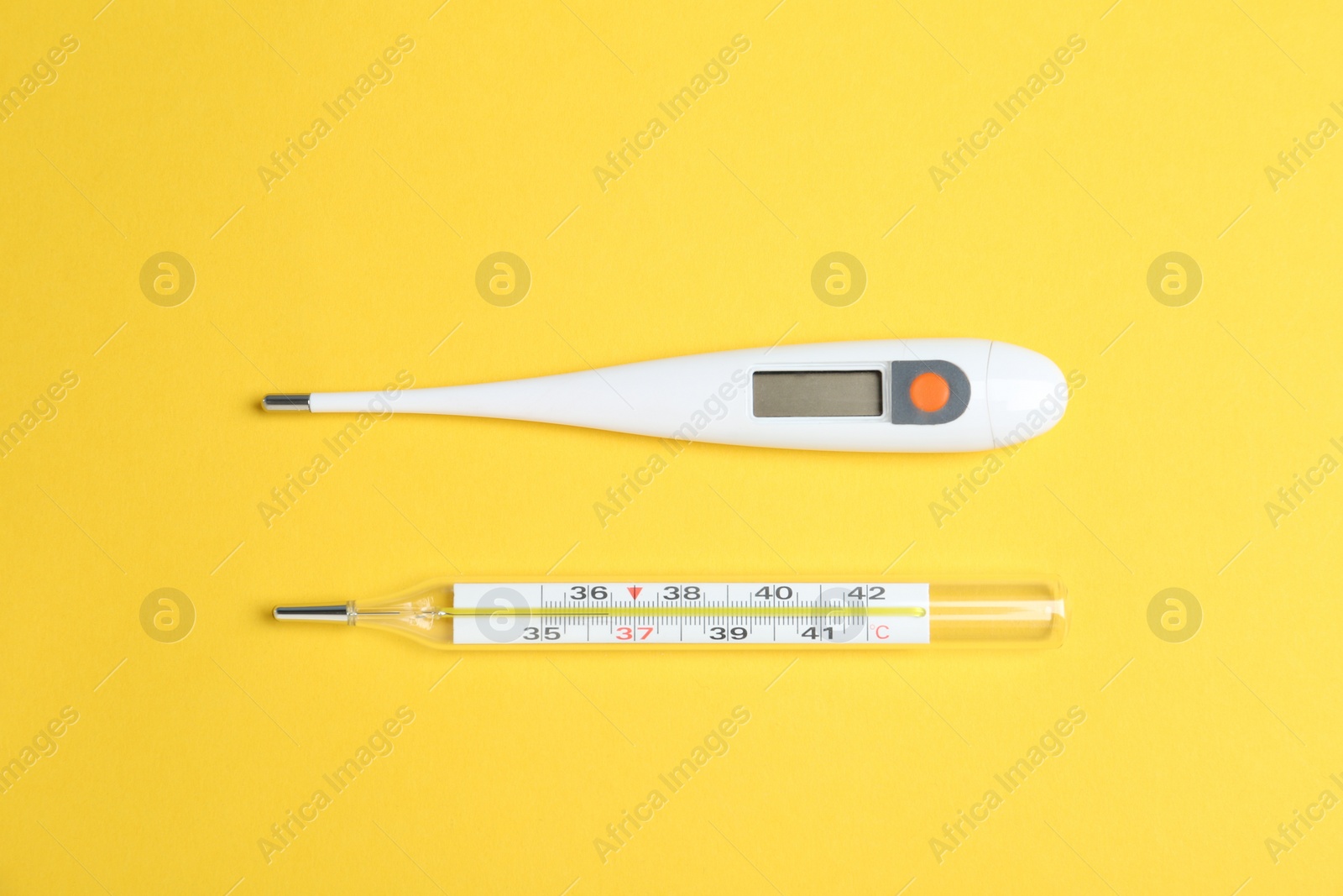 Photo of Different thermometers on yellow background, flat lay