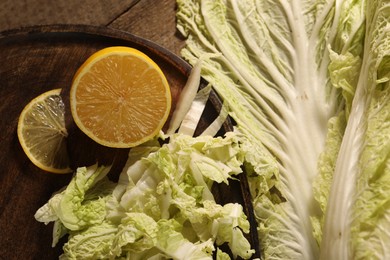 Photo of Fresh Chinese cabbage and lemon on table, top view