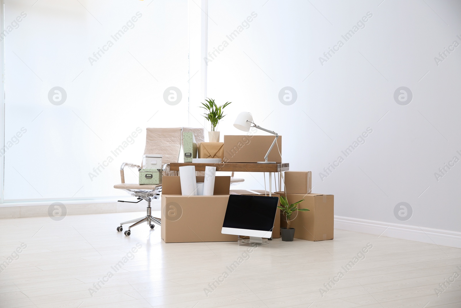 Photo of Moving boxes and furniture in new office