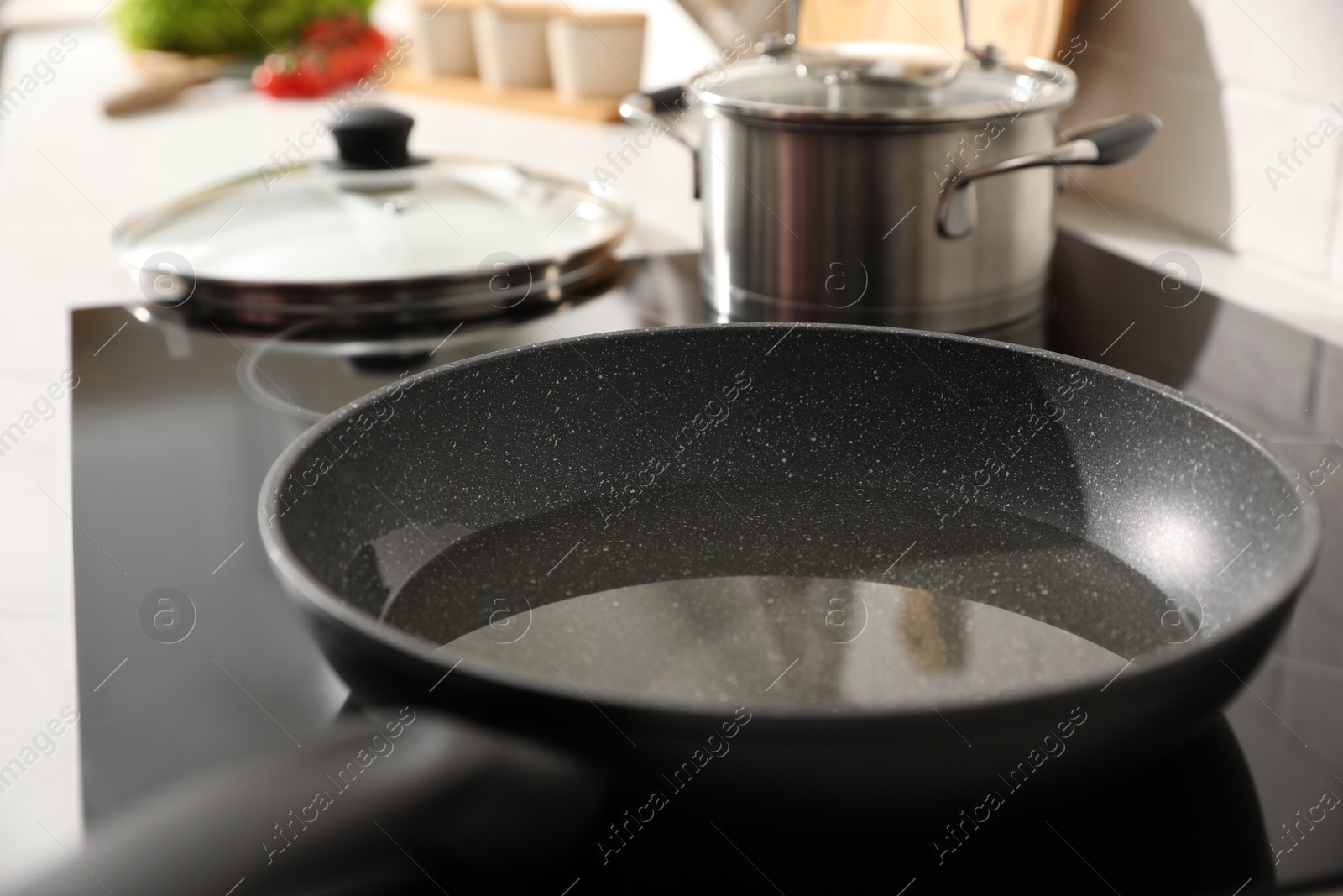 Photo of Frying pan with cooking oil on cooktop