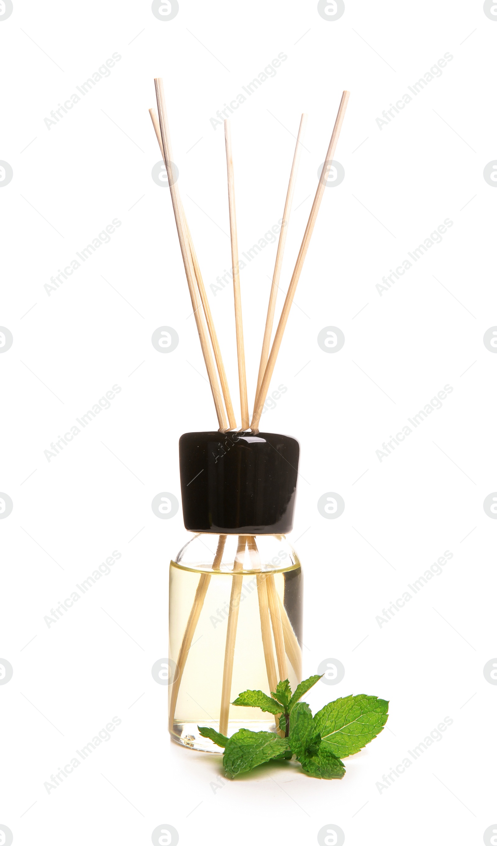 Photo of Aromatic reed air freshener and mint on white background