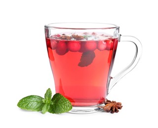 Photo of Tasty hot cranberry tea with mint and anise in glass cup on white background