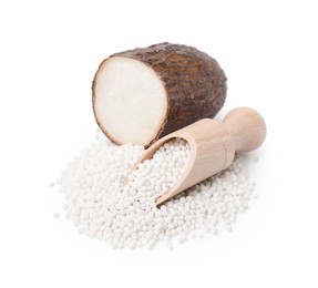 Pile of tapioca pearls, scoop and cassava root isolated on white