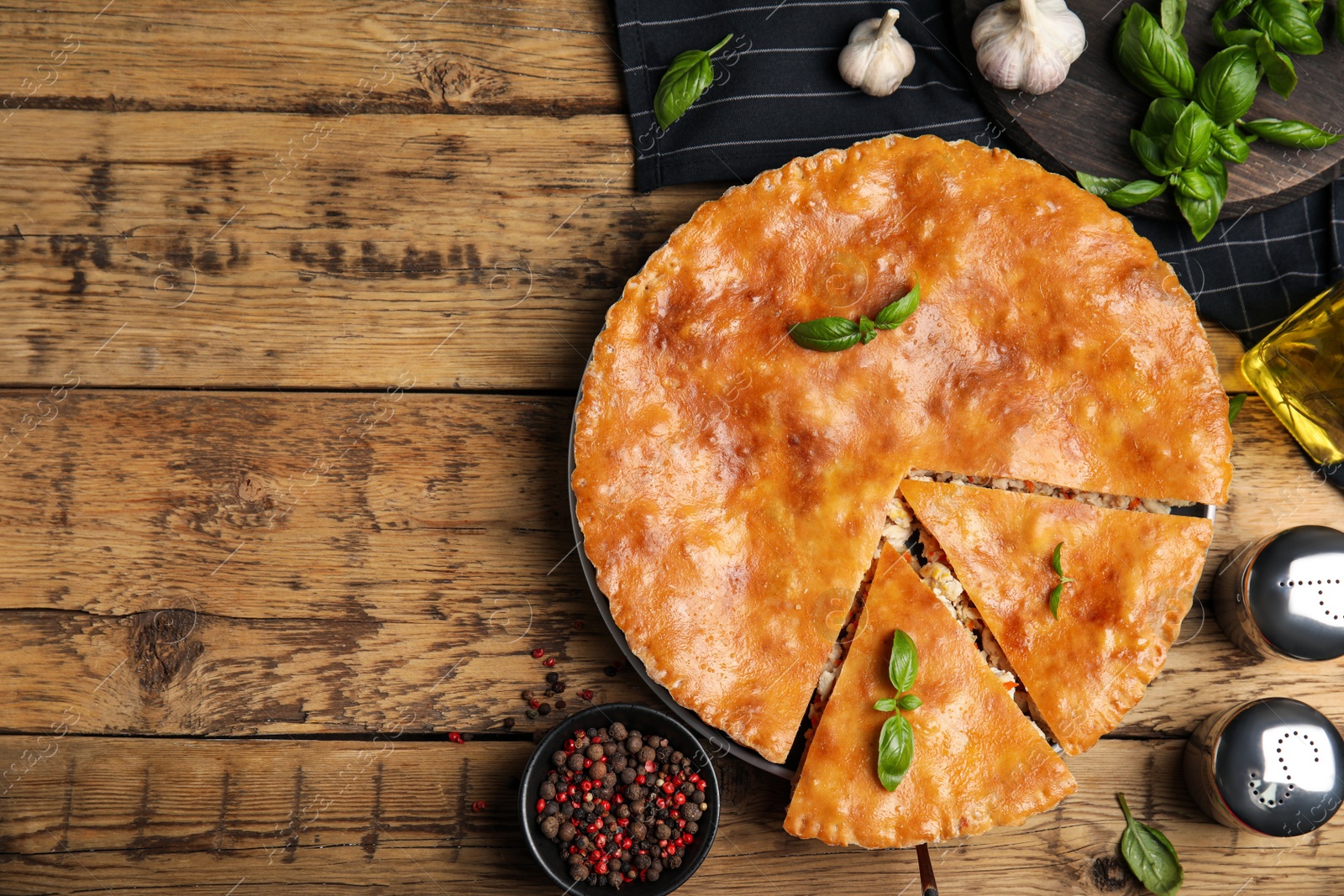 Photo of Delicious meat pie served on wooden table, flat lay. Space for text