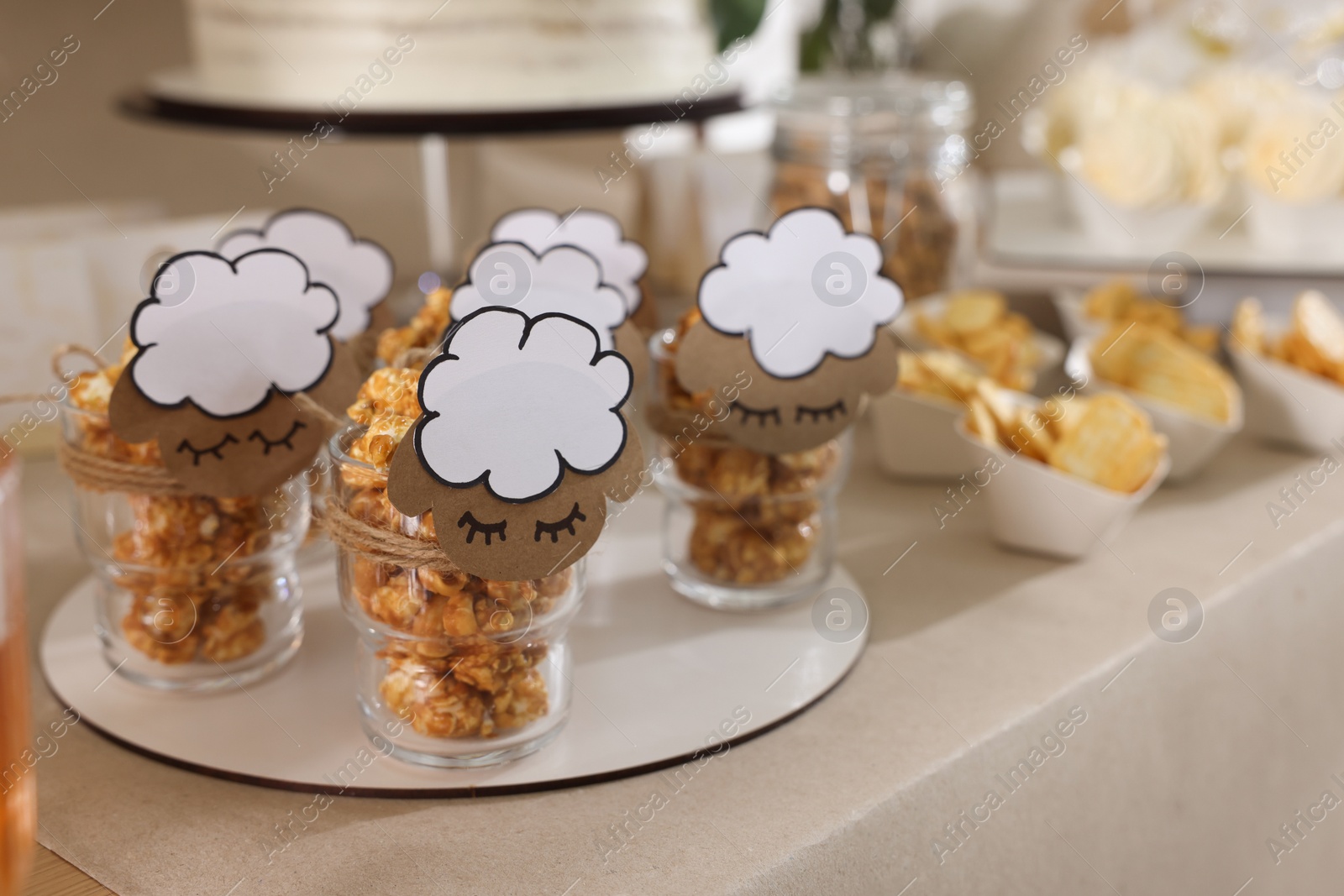 Photo of Tasty treats on table in room decorated for baby shower party