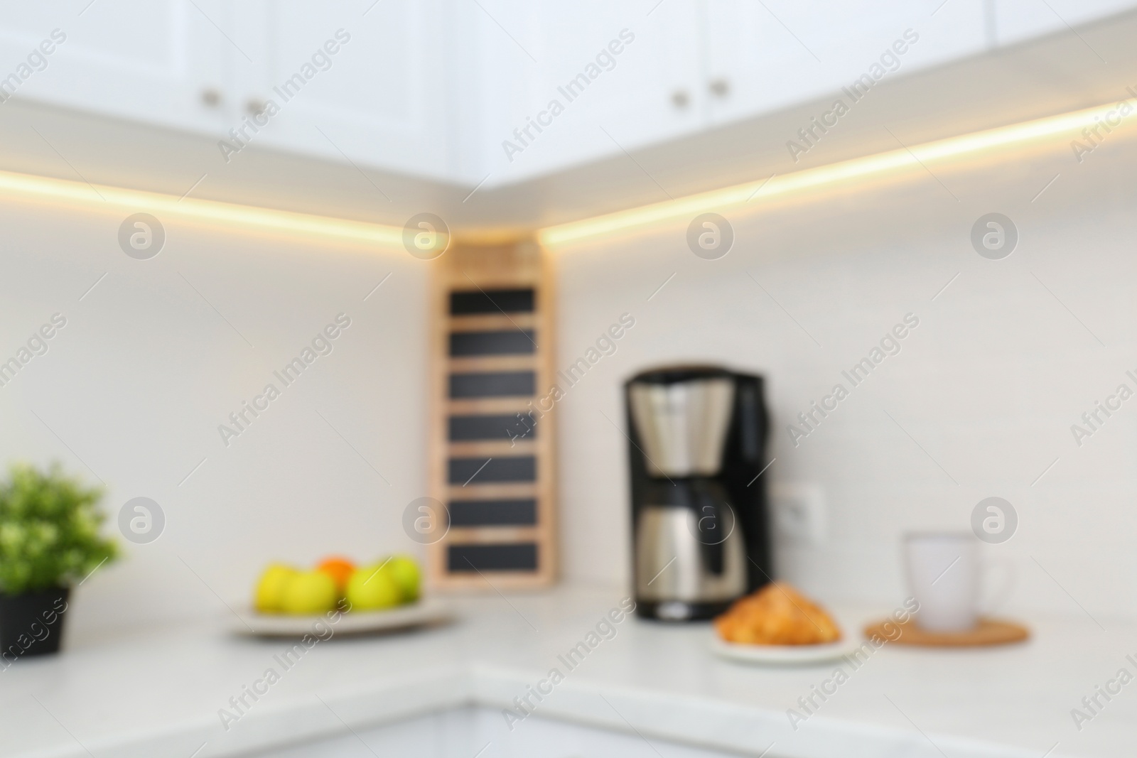 Photo of Blurred view of modern kitchen with coffee maker