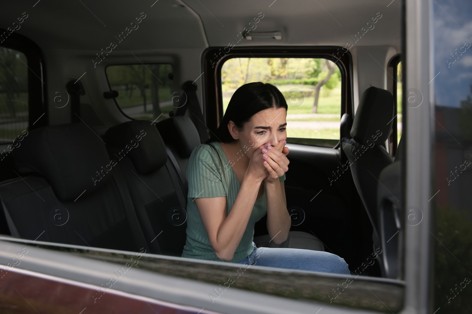 Photo of Young woman suffering from nausea in car