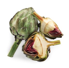 Photo of Cut and whole fresh artichokes on white background, top view