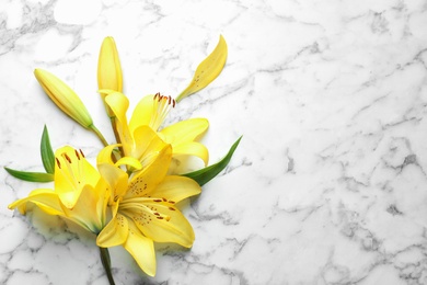 Photo of Flat lay composition with beautiful blooming lily flowers on marble background