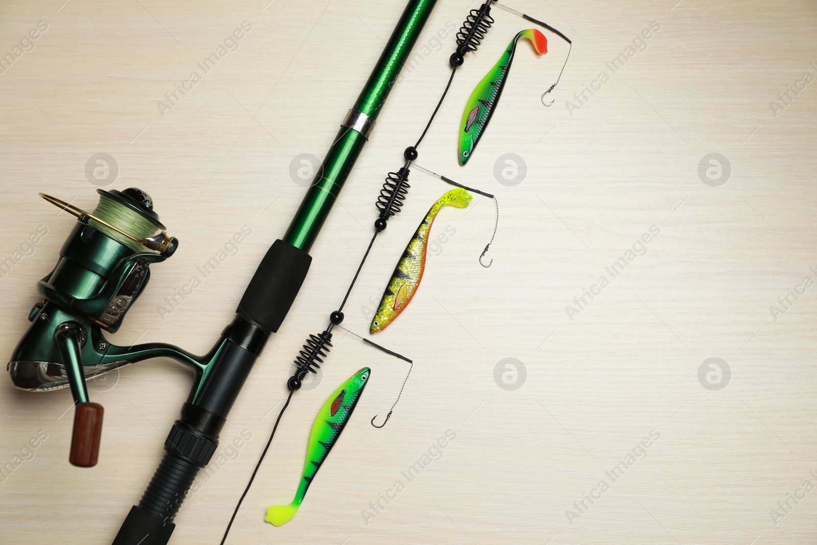 Photo of Fishing tackle on wooden background, flat lay. Space for text