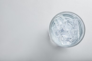 Glass of soda water with ice isolated on white, top view