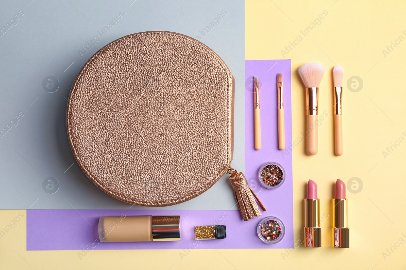 Photo of Flat lay composition with cosmetic products and makeup brushes on color background