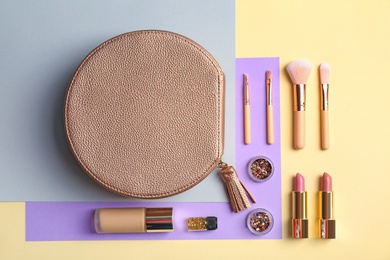 Flat lay composition with cosmetic products and makeup brushes on color background