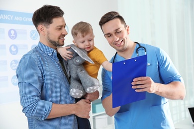 Father with child visiting doctor in hospital