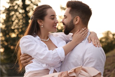 Photo of Lovely couple dancing together outdoors at sunset