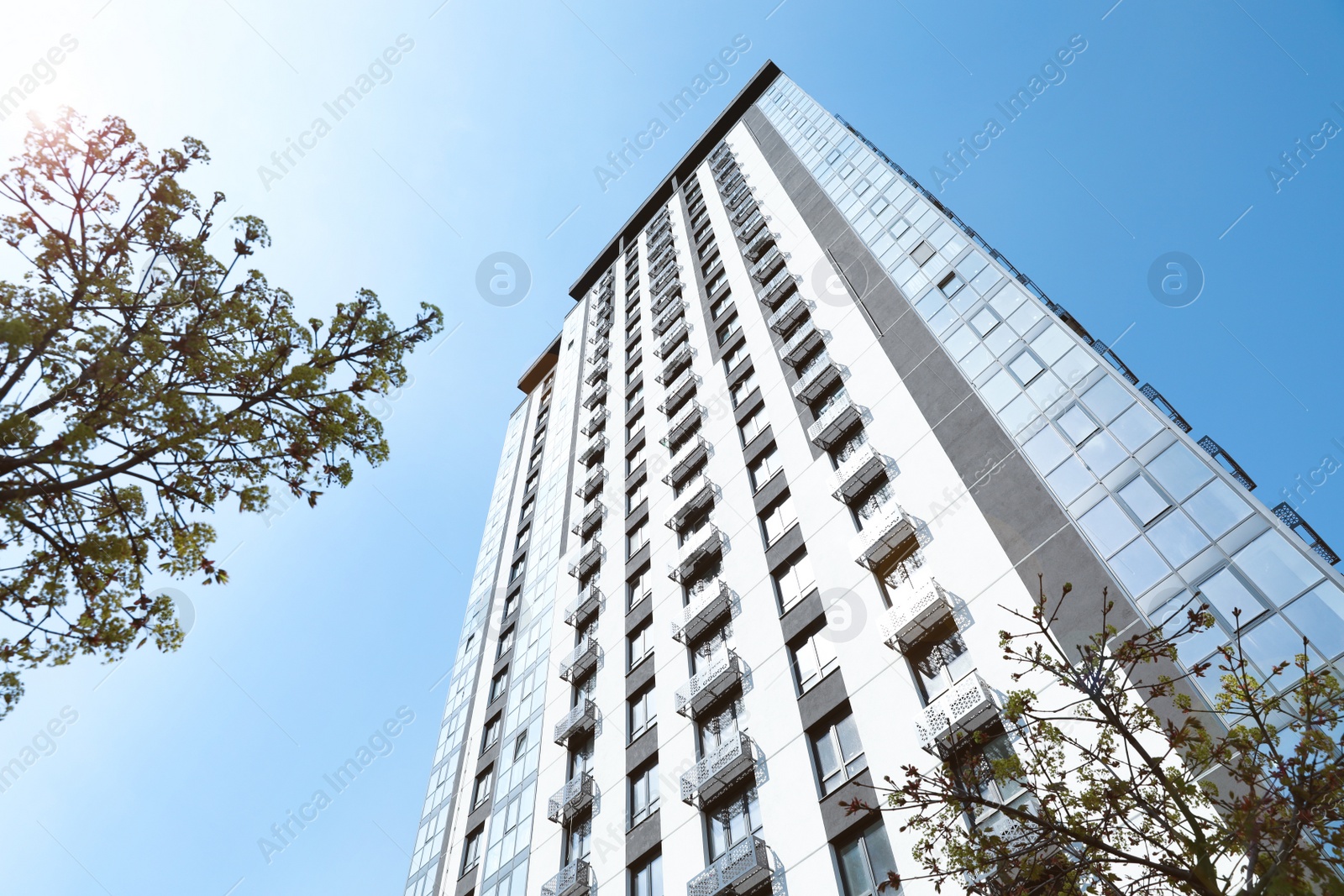 Photo of Low angle view of modern building against blue sky