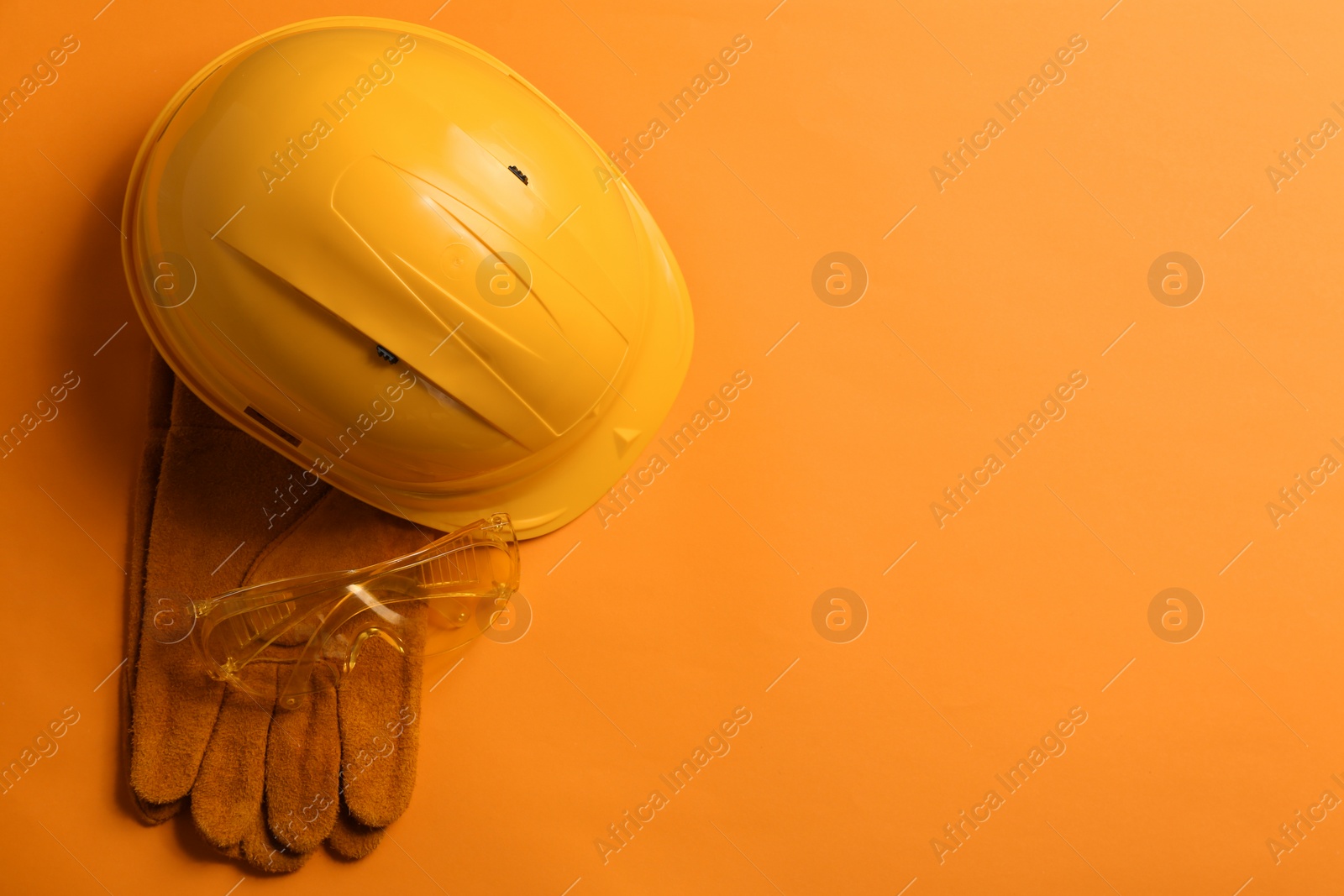 Photo of Flat lay composition with safety equipment and space for text on color background