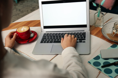 Photo of Blogger working with laptop in cafe, closeup