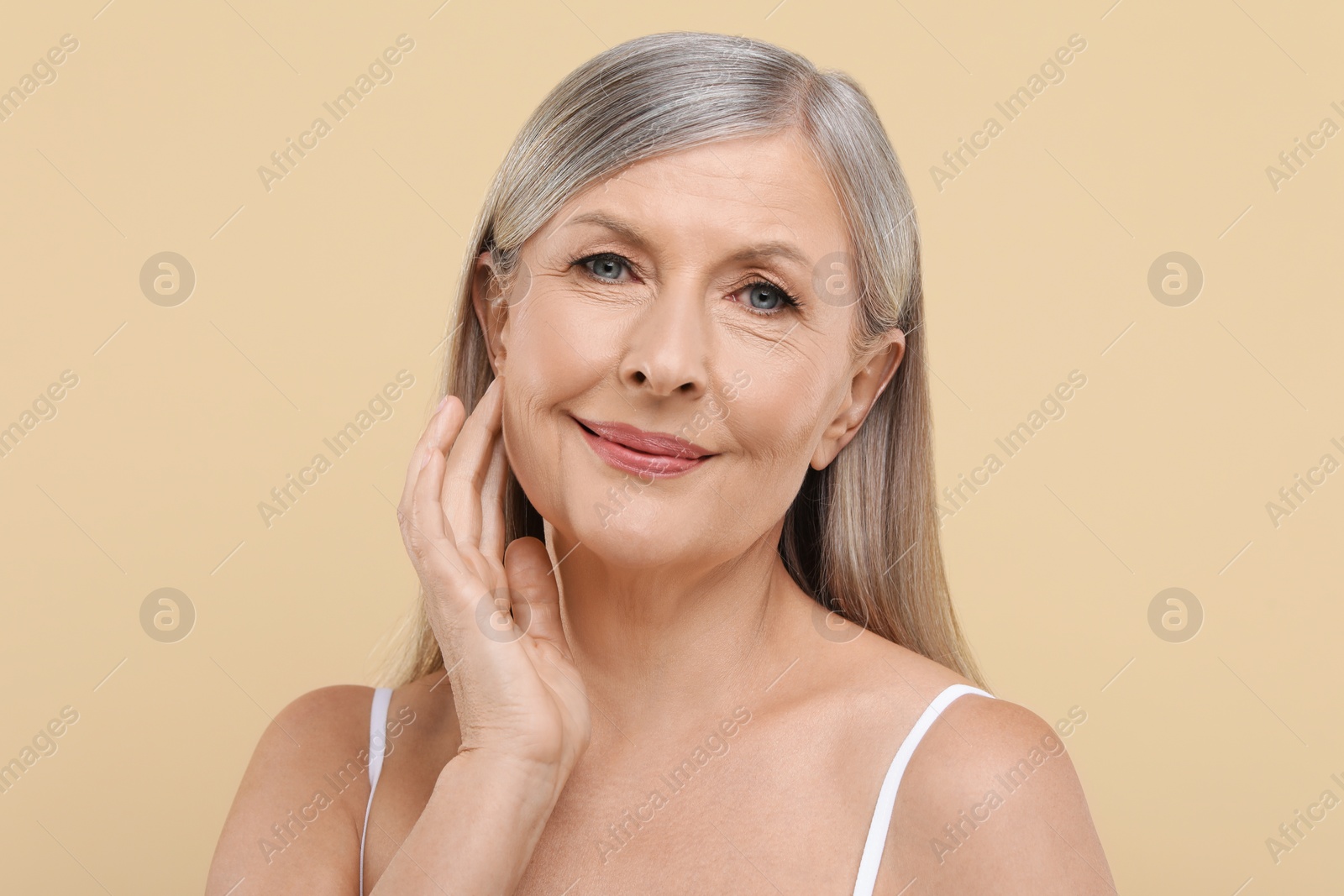 Photo of Portrait of beautiful senior woman on beige background