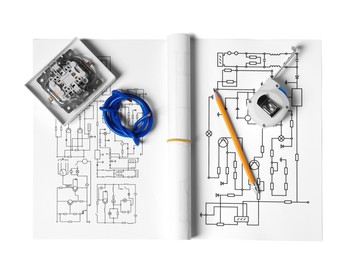 Wiring diagrams, wires, disassembled light switch, tape measure and pencil isolated on white, top view