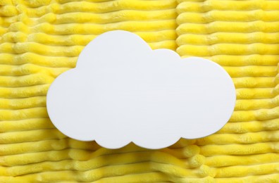 Photo of Cloud shaped child's night lamp on yellow fabric, top view