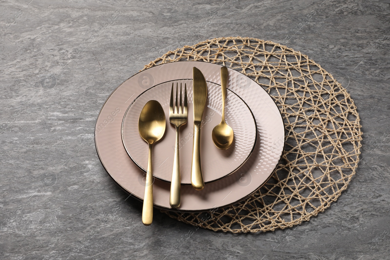 Photo of Stylish table setting with cutlery on grey surface