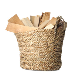 Wicker basket with cut firewood isolated on white