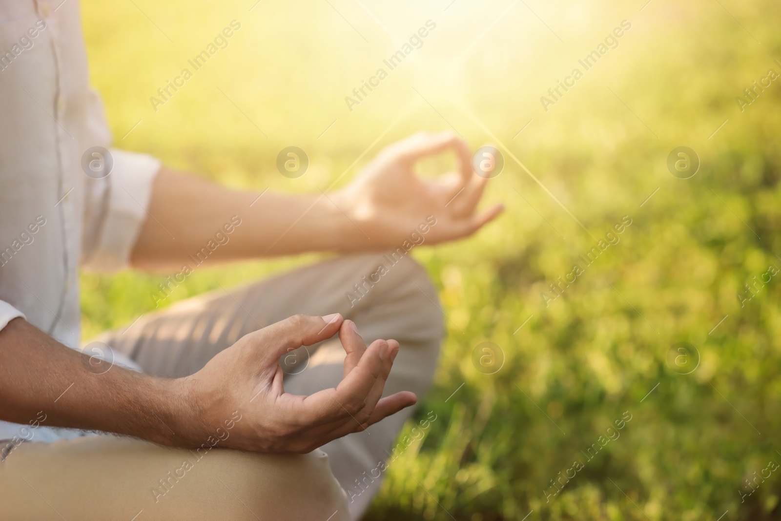 Image of Man meditating outdoors on sunny day, closeup. Practicing yoga