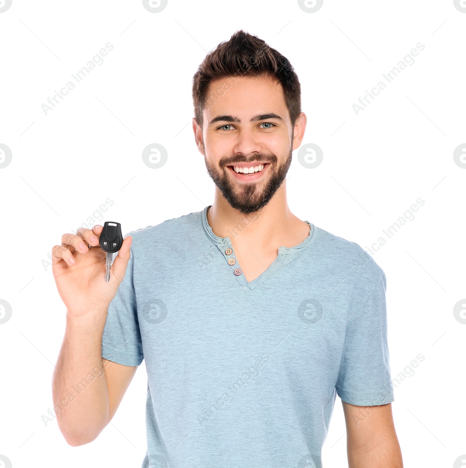 Photo of Happy young man with car key on white background. Getting driving license