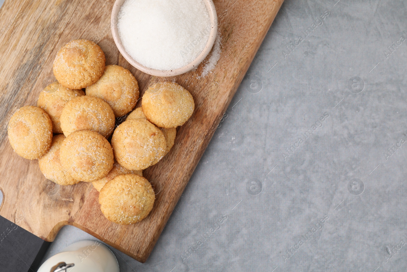 Photo of Tasty fresh sugar cookies on grey table, top view. Space for text