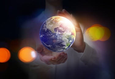 Image of World in our hands. Woman holding digital model of Earth, closeup view 