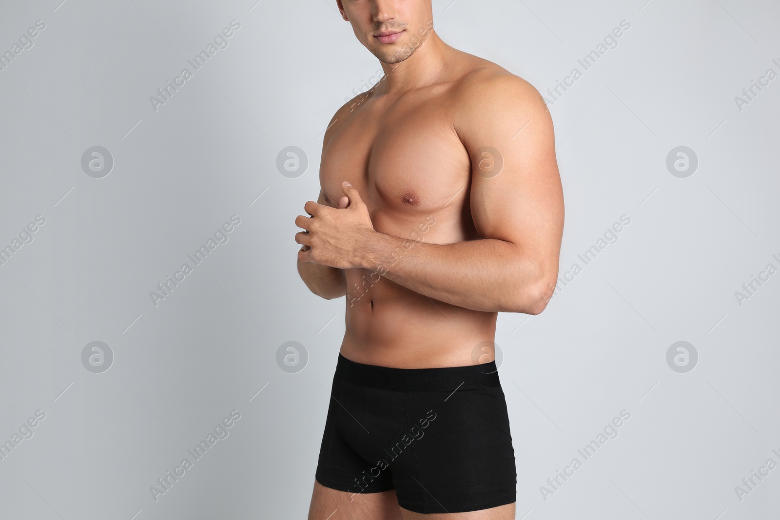 Photo of Man with sexy body on light background, closeup