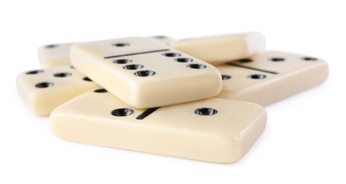 Photo of Pile of classic domino tiles on white background