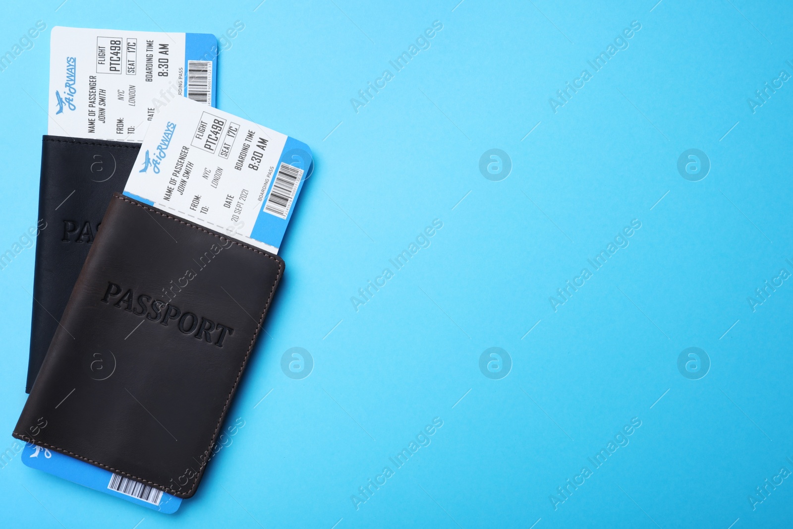 Photo of Passports with avia tickets on light blue background, flat lay with space for text. Travel agency concept