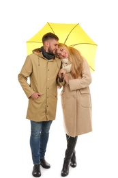 Full length portrait of beautiful couple with umbrella, isolated on white