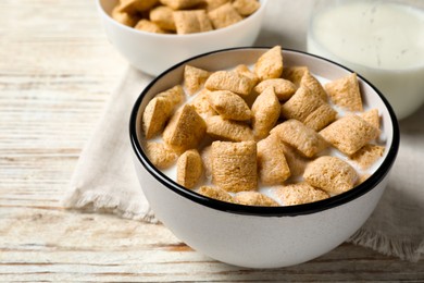 Photo of Tasty corn pads with milk served for breakfast on white wooden table, closeup