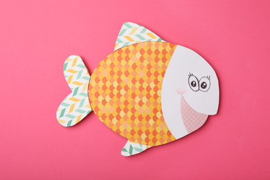 Photo of Funny paper fish on pink background, top view. April Fool's Day