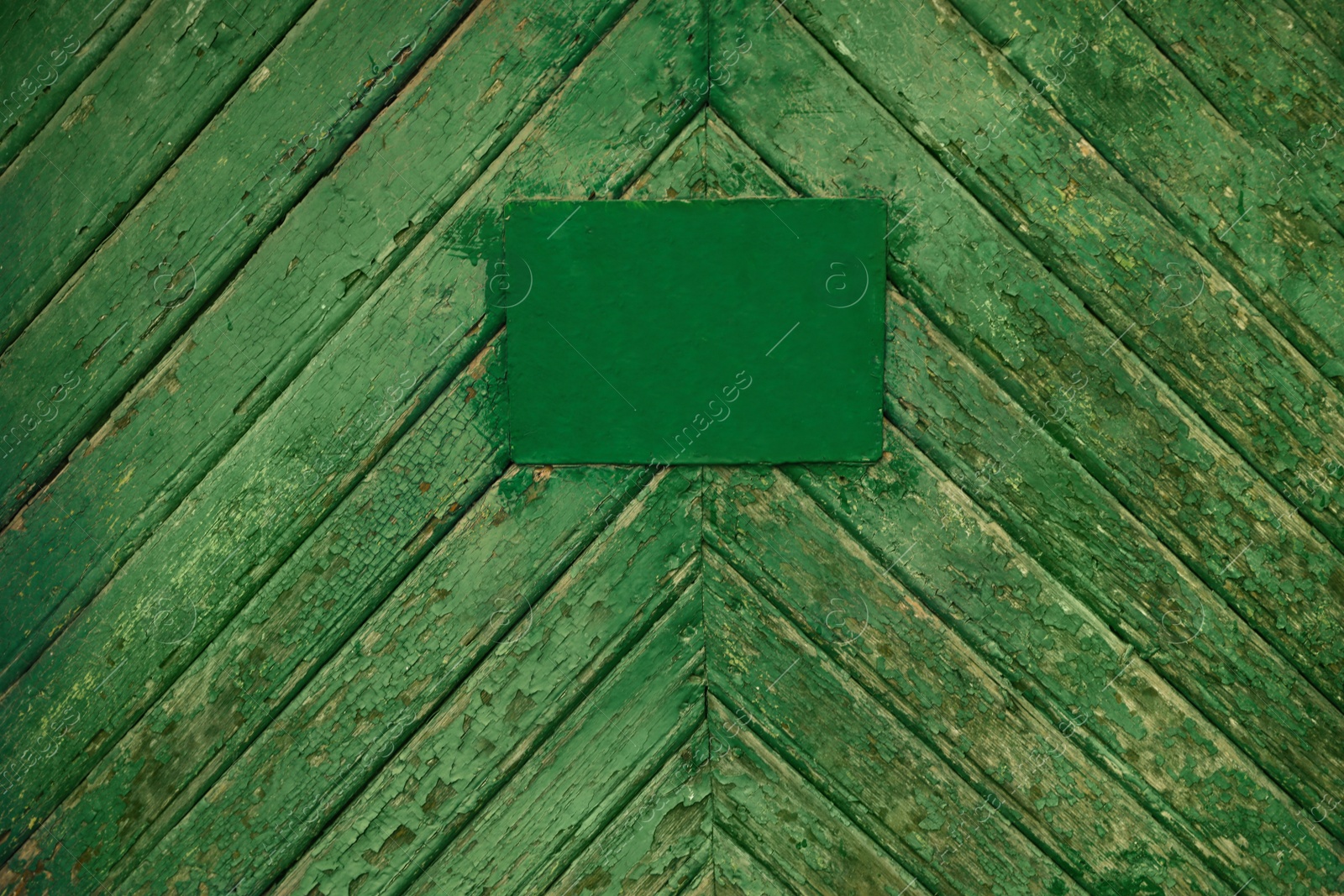 Photo of Textured old wooden surface with stained signboard as background