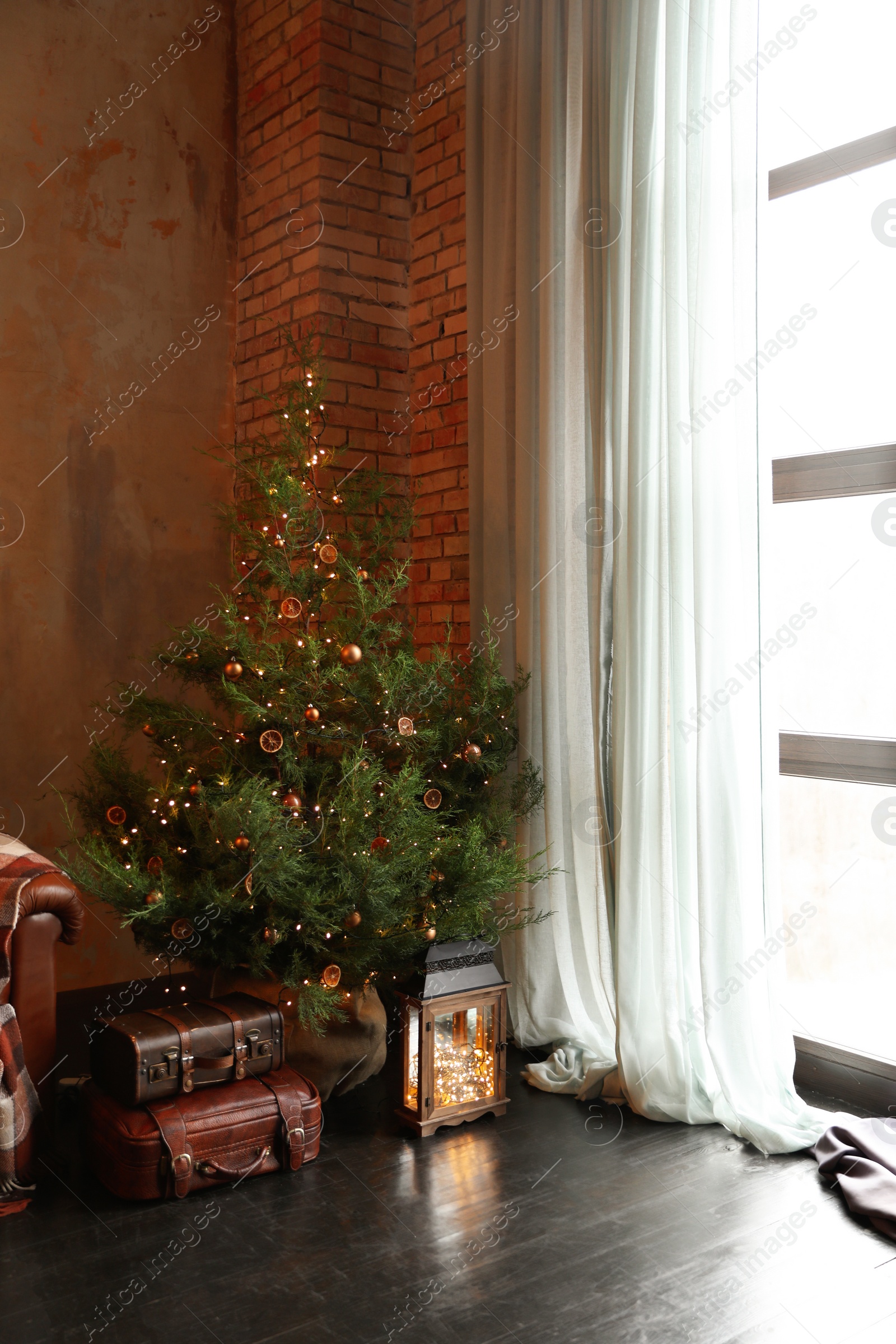 Photo of Festive living room interior with decorated Christmas tree