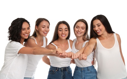 Photo of Happy women putting hands together on white background. Girl power concept