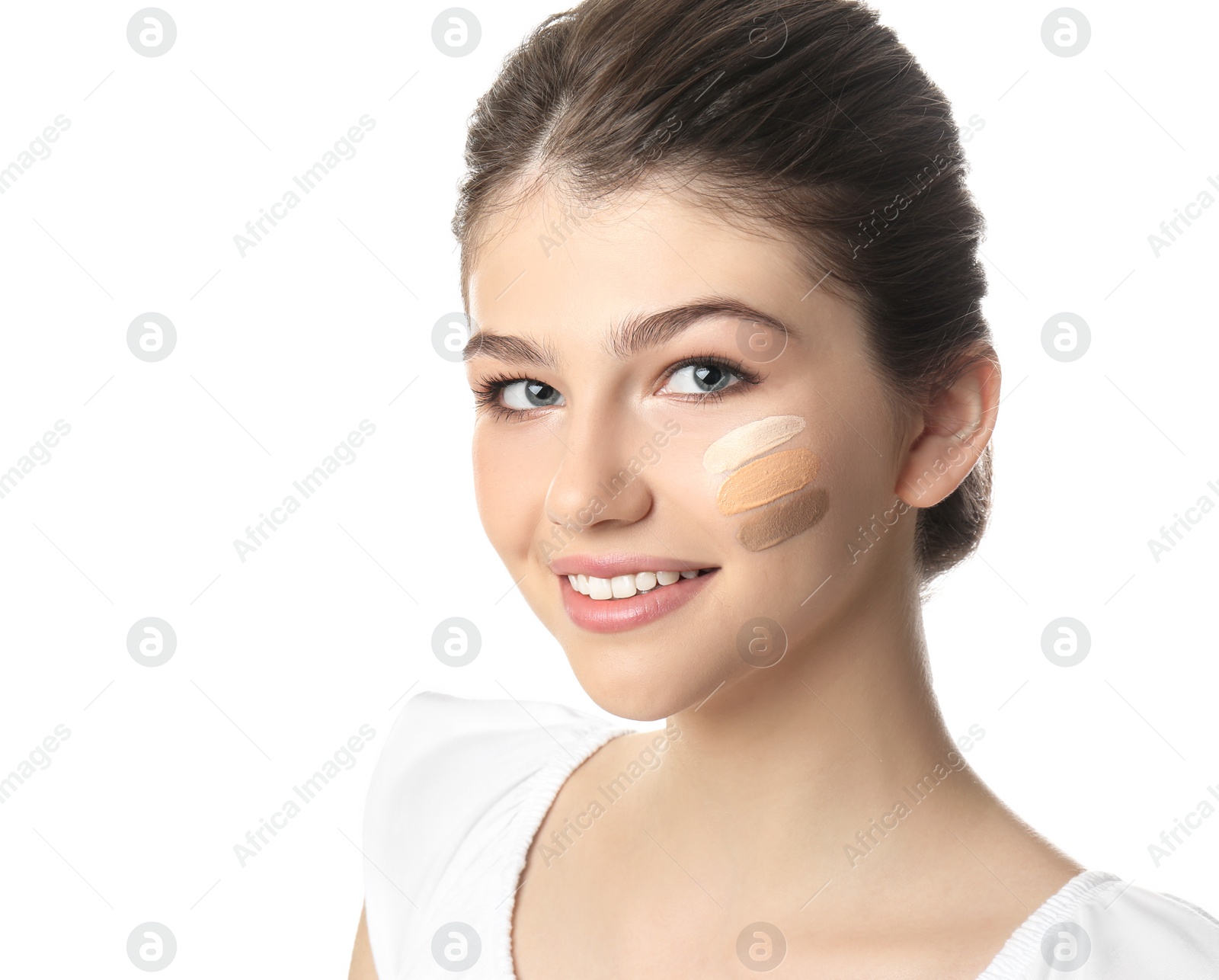 Photo of Beautiful girl on white background. Using concealer and foundation for face contouring