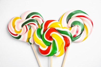 Photo of Sticks with different colorful lollipops on white background, flat lay