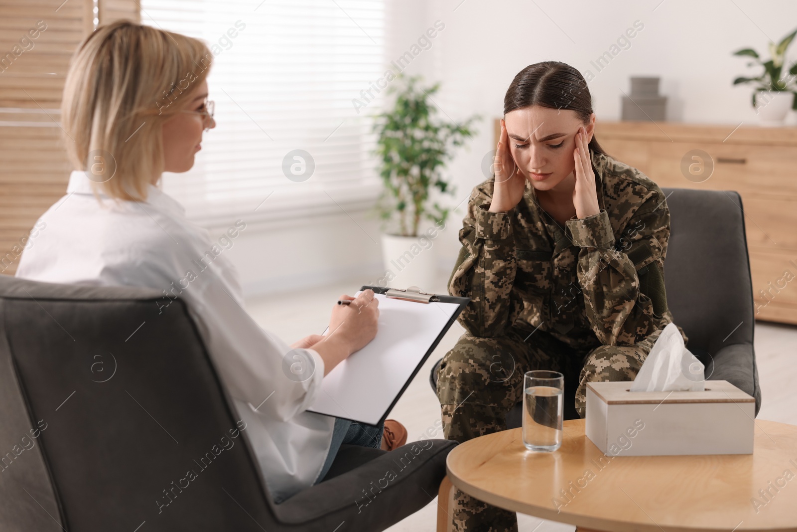 Photo of Psychotherapist working with military woman in office