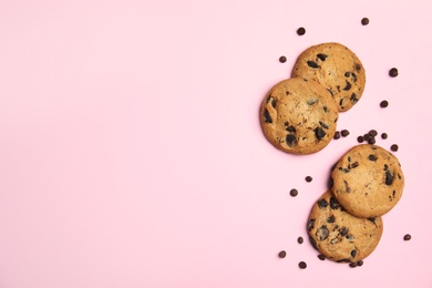 Delicious chocolate chip cookies on color background, flat lay. Space for text