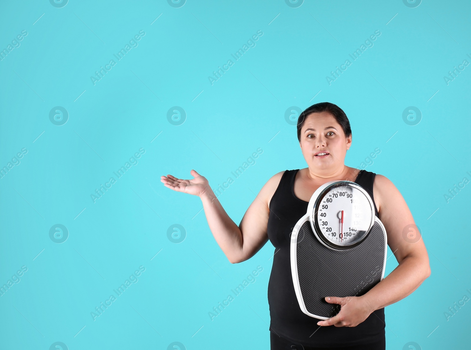 Photo of Overweight woman in sportswear with scales on color background