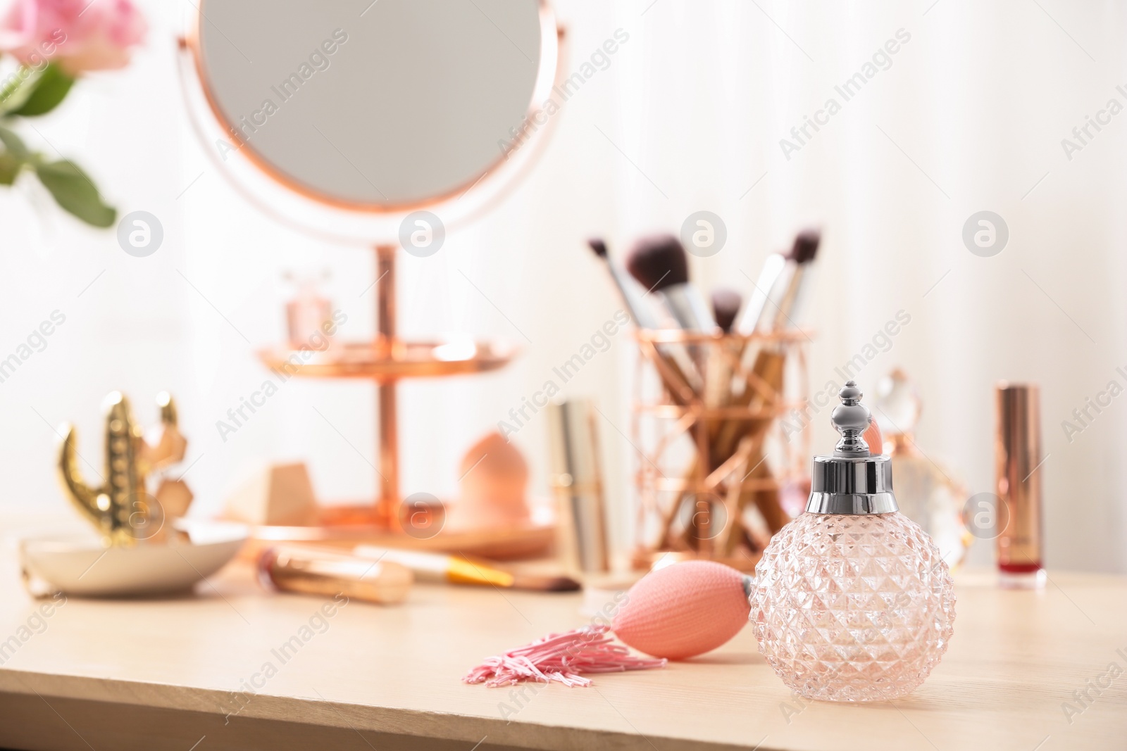 Photo of Perfume bottle on dressing table, space for text