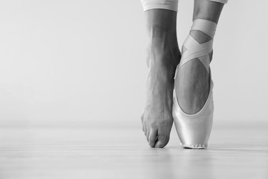 Image of Ballerina in pointe shoe dancing, closeup with space for text. Black and white effect