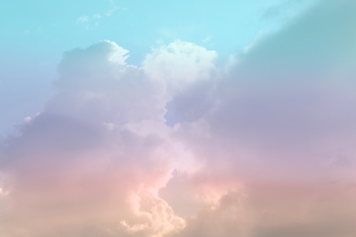 Image of Fantasy world. Picturesque view of beautiful magic sky with fluffy clouds, toned in pastel rainbow or unicorn colors