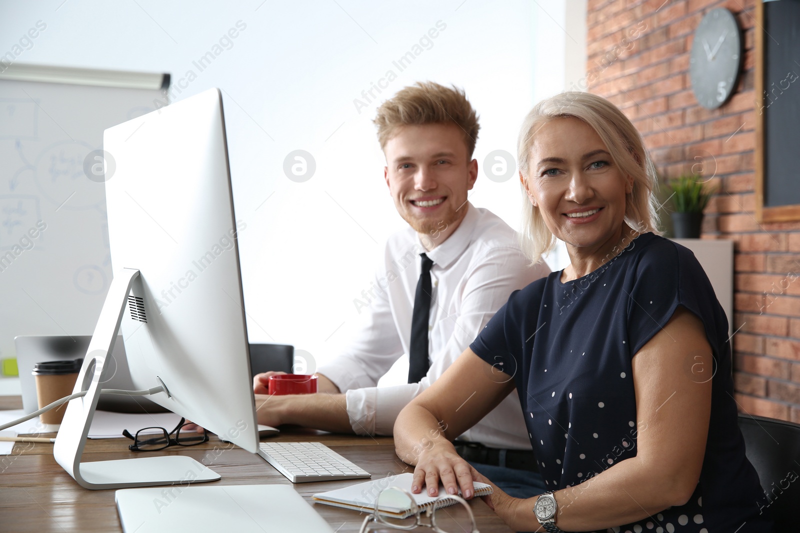 Photo of Business people working on computer at table in office. Professional communication